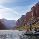 Two men and a woman raft on Colorado River in Grand Canyon