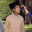 Maddy Rehrman, commencement coordinator for the College of Letters and Science, demonstrates proper tassel etiquette. Her model is Eric Zamora, and lo