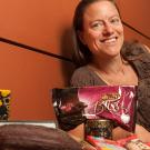 Woman lying on bench next to various chocolate foods
