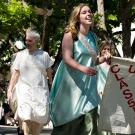 Woman in a toga in a parade with a "UCD Classics" banner
