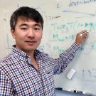Scientist Da Yang at whiteboard 