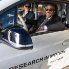 UC Davis Chancellor Gary S. May and BMW's Monterey Gardiner behind the wheel of an electric i3