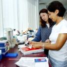 photo of Nina Aboughanem and Cristina Rosa working on a gel protein