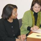 Staci Bates, left, consults with Ellie Sandoval, Bate&rsquo;s supervisor while she is taking part in a pilot internship program in human resources.