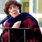 Photo: Professor Naomi Janowitz in academic regalia, behind podium