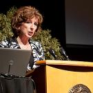 Standing at a podium, Chancellor Linda Katehi shows her resolve to rally forces for policy and research breakthroughs
