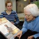 Photo: Woman pointing to movie poster for female student.