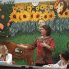 Against the backdrop of a mural painted last year, Diane Ullman teaches the freshman seminar Scientific Illustration in Public Murals, as students Madeline Osborn, left, and Karen Tam look on.   