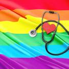 Stethoscope and heart atop rainbow flag