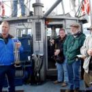 UC Davis researcher Brant Allan, left, demonstrates for media the thermometer used to measure lake water temperature. Those looking on include Geoffrey Schladow, director of the UC Davis Tahoe Environmental Research Center, far right, and UC Dav