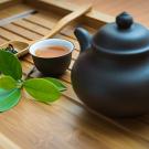 Bamboo tray holds tea leaves and teapot