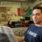 A man reads The California Aggie