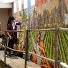 student painting a mural