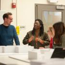 l to r) Professor Tim McNeil listens as Ama Bonsu talks about their layout as Millie Lozano and Zhou Zhou listen during the design exhibition class on February 12, 2019.  The students pick an anniversary in 2019 to showcase and design how the show will work in the Manettie Shrem Musuem.