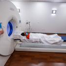 Person lying on table about to enter medical scanner