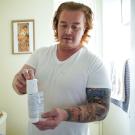 Matthew Treviño holds a canister of a hormonal birth control gel for men while in his home in Sacramento. He is part of a clinical trial at UC Davis Health testing the new drug. 