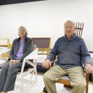 Older couple sitting in light wooden furniture
