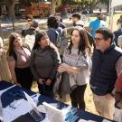 Luis Carvajal-Carmona and three students at a booth at the Graduate and Law School Fair on the Quad.