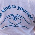 "Be Kind to Yourself" T-shirt, with hands making a heart