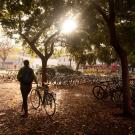 A student walks to park her bike at UC Davis
