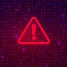 Alert symbol: Red triangle and exclamation point against background of computer code
