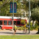 Russell Boulevard scene with Unitrans bus, pedestrian and bicyclist