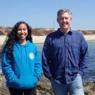 Jacquie Rajerison (left) and Professor Eric Sanford (right) smile outside by the beach at the Bodega Marine Reserve