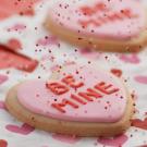 Valentine cookie reading "Be Mine"
