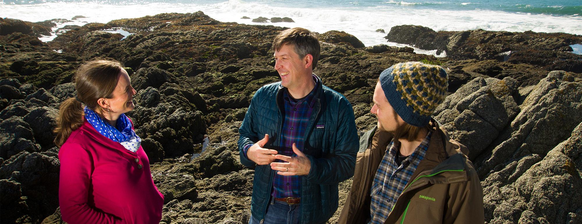 two students working with a professor on research at Bodega Bay Marine Lab