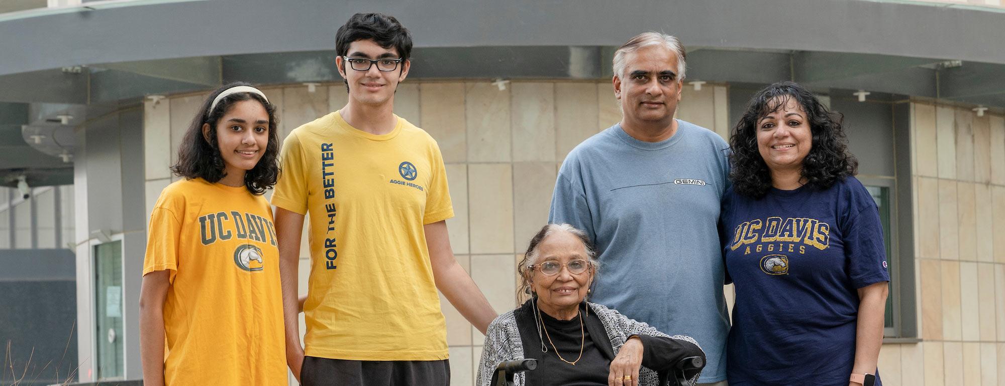 Three generations of a UC Davis family pose for a portrait.
