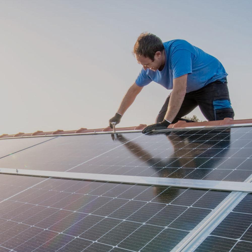 A worker polishes a solar panel