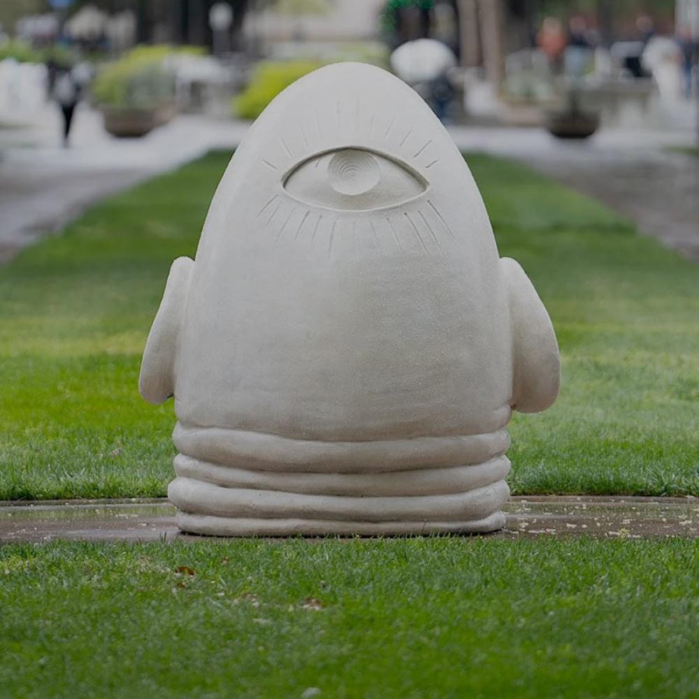 The egghead statue "Eye on Mrak," an upsidfe down egg smushing into the ground with a third eye on its backside, on the Mrak mall at UC Davis