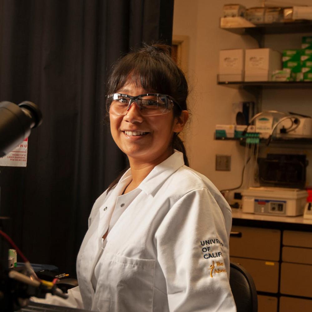 A female researcher smiles in her lab