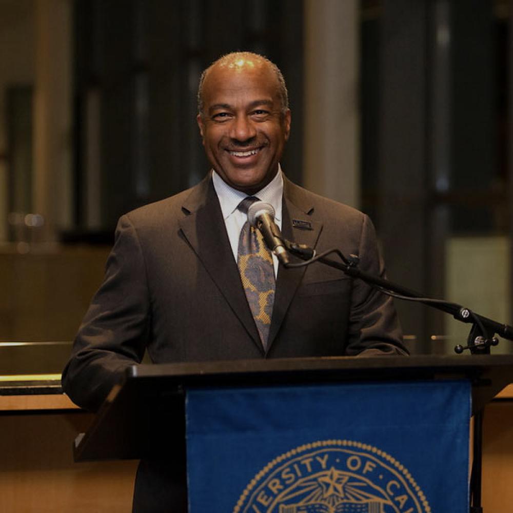UC Davis chancellor Gary May speaking from a podium