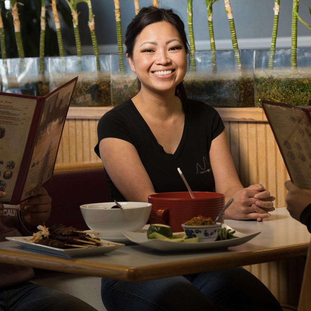 A woman sits in a booth at a local restaurant in Davis, ca