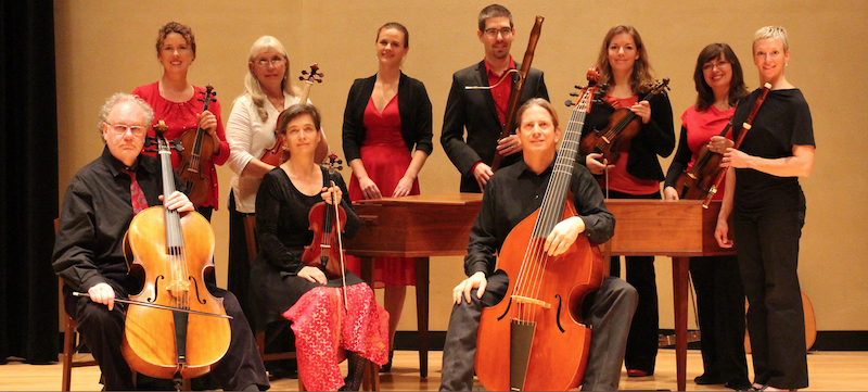The Sacramento Baroque Soloists posing on stage with their instruments.