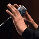 closeup of a microphone and hands