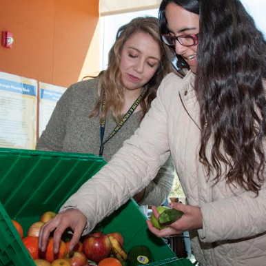 A student reaches for some produce