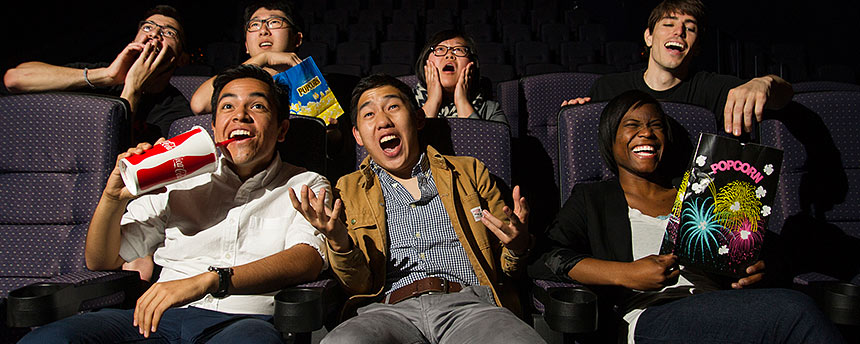 Autidence of students in a movie theater having fun
