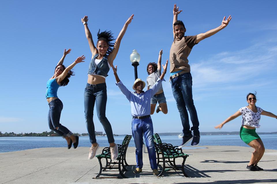 The Havana Cuba All-Star dancers jumping in mid-air.