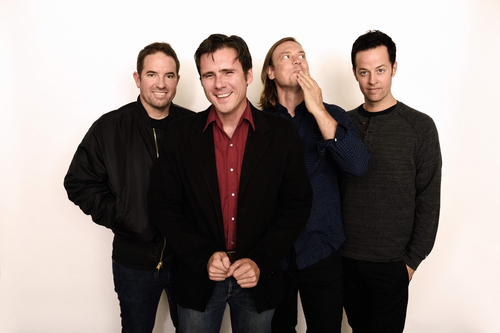 The band standing in front of a white background.