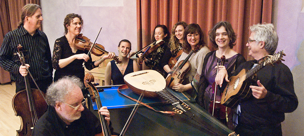 The Sacramento Baroque Soloists smiling with their instruments.