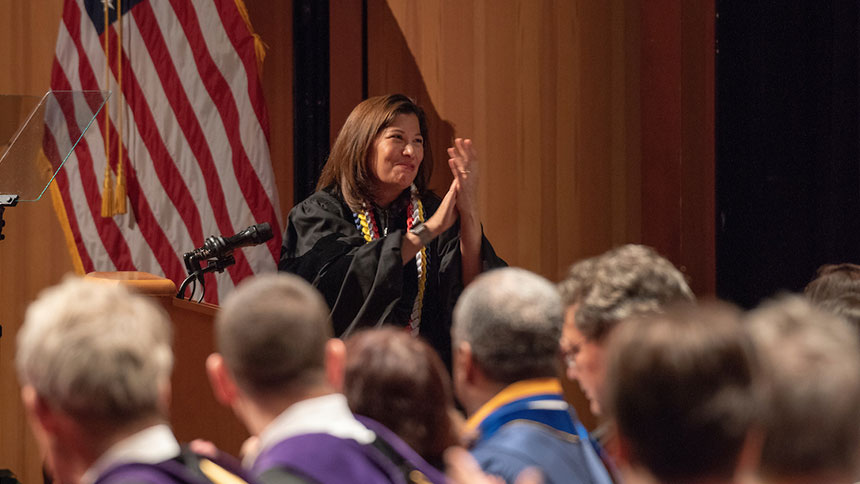 Woman speaker applauds graduates at School of Law commencement