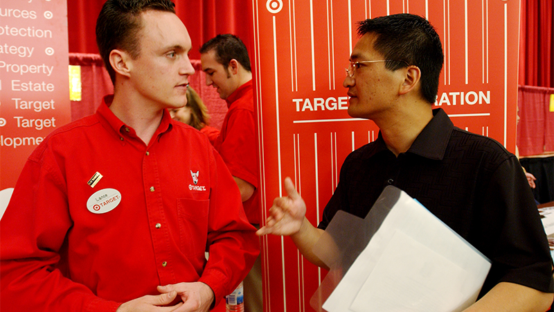 An employer and student talk at a career fair