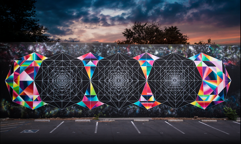 A photo of a mural displaying geometric shapes, both colorful and black-and-white.